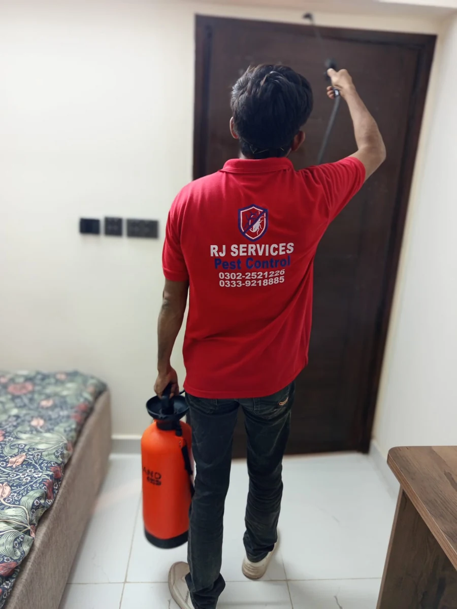 RJ Services technician applying an indoor treatment around a doorway